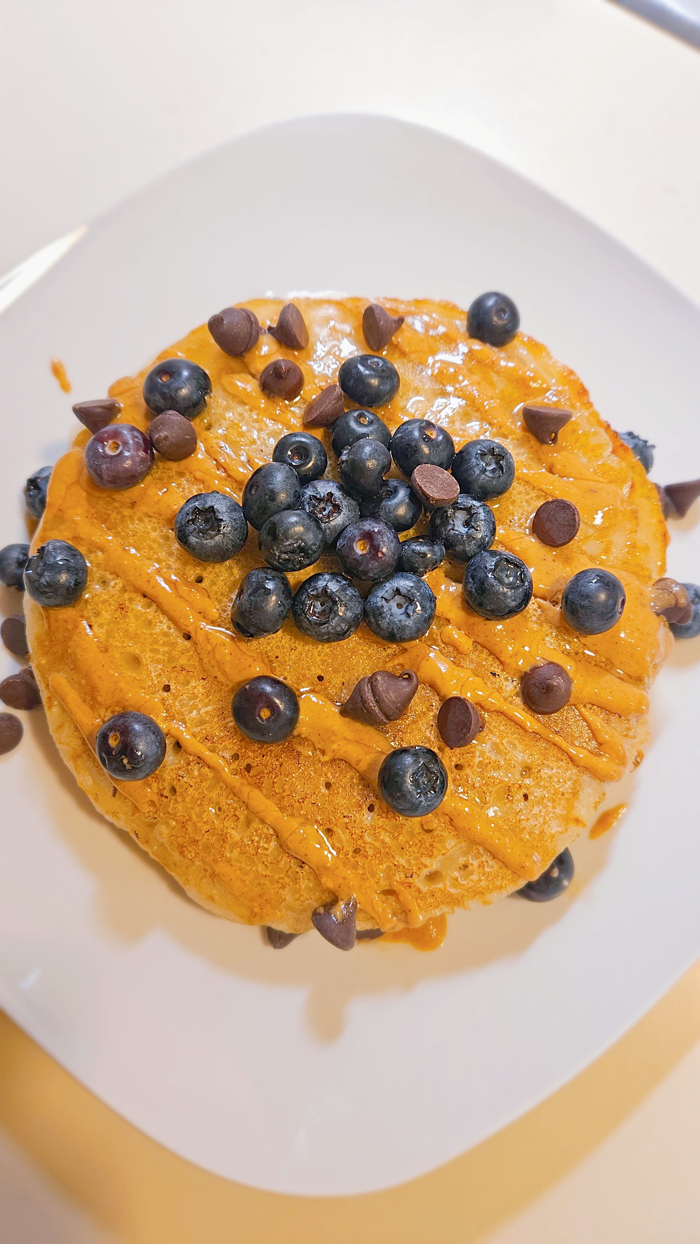 A tall stack of pancakes at a diner